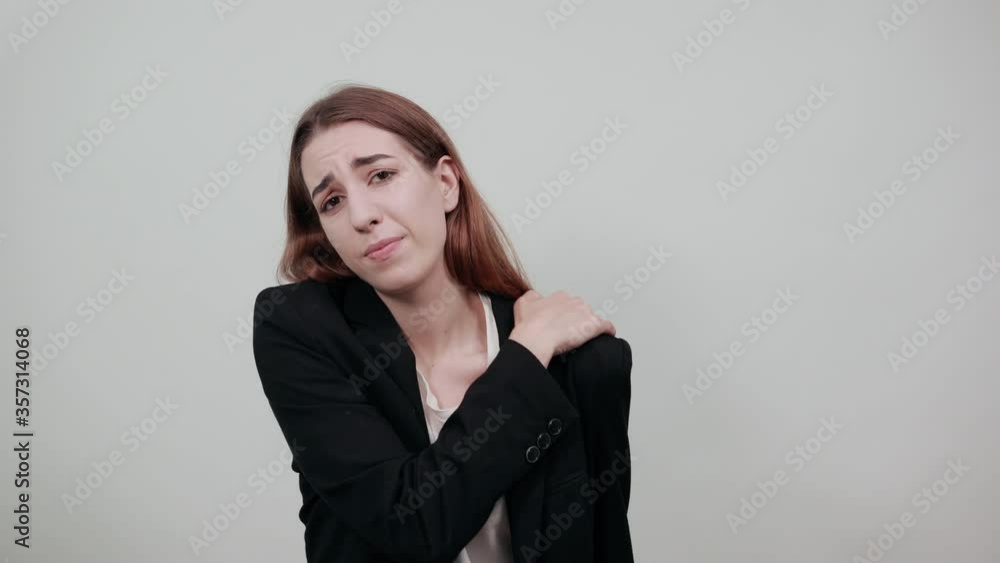 Holds the shoulder hurts, pain in my arm, sore point, problem with health care and exercise. Feel hurt. Terrible ache in spine. Exercises for back. Young attractive woman with brown hair Holds the shoulder hurts, pain in my arm, sore point, problem with health care and exercise. Feel hurt. Terrible ache in spine. Exercises for back. Young attractive woman with brown hair