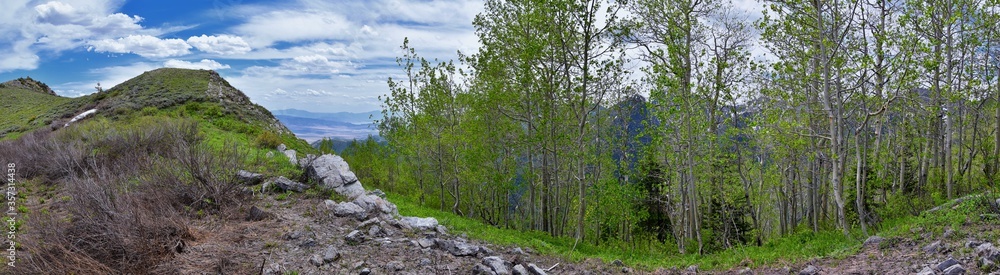 Fototapeta premium Rocky Mountain Wasatch Front peaks, panorama landscape view from Butterfield Canyon Oquirrh range toward Provo, Tooele Utah Lake by Rio Tinto Bingham Copper Mine, Great Salt Lake Valley in spring. Uta