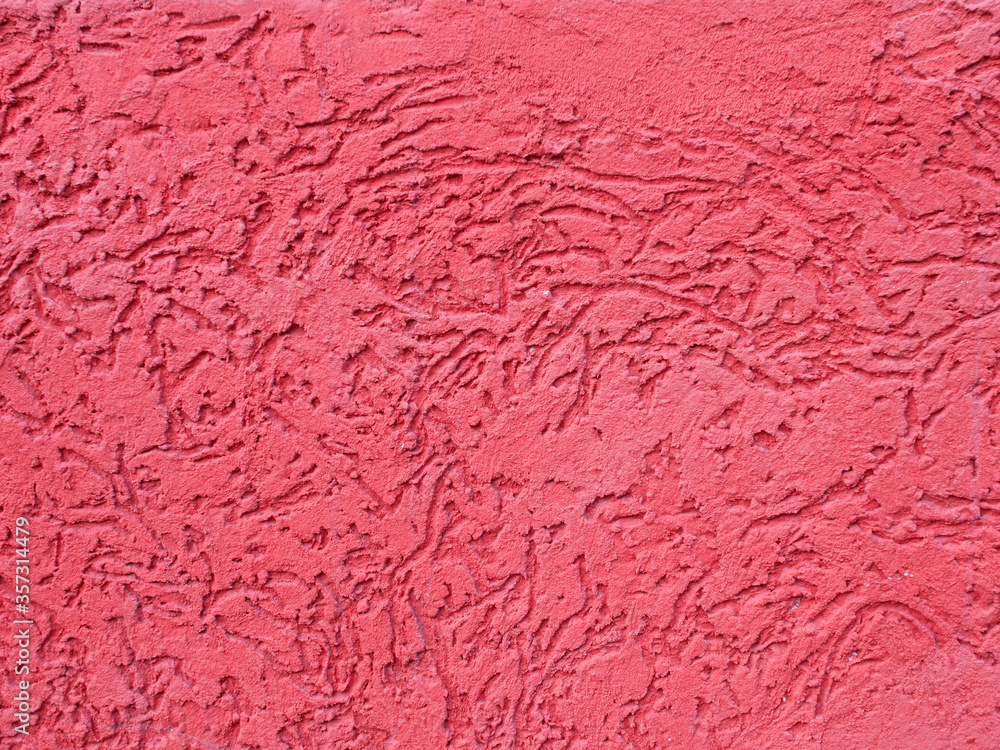 small plaster applied red plaster on the wall, textured surface