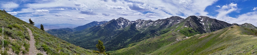 Rocky Mountain Wasatch Front peaks, panorama landscape view from Butterfield Canyon Oquirrh range toward Provo, Tooele Utah Lake by Rio Tinto Bingham Copper Mine, Great Salt Lake Valley in spring. Uta