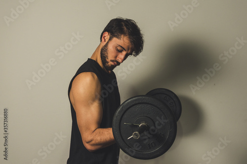 young man lifting weights
