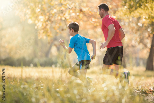 Father and son jogging in park