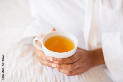 Close up woman holding cup of tea photo