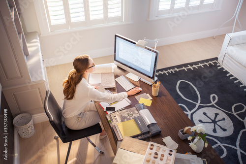 Interior designer working at computer in home office