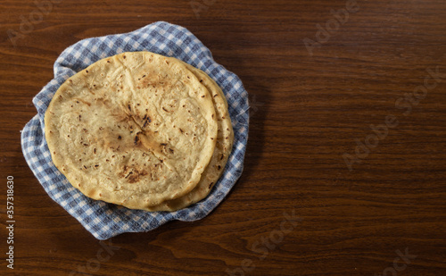 Corn tortilla on checkered tablecloth, delicious Latin American vegan food