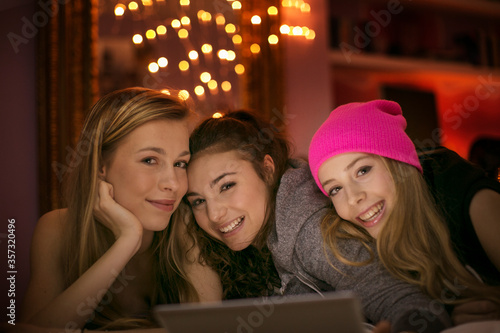 Portrait smiling teenage girls using digital tablet