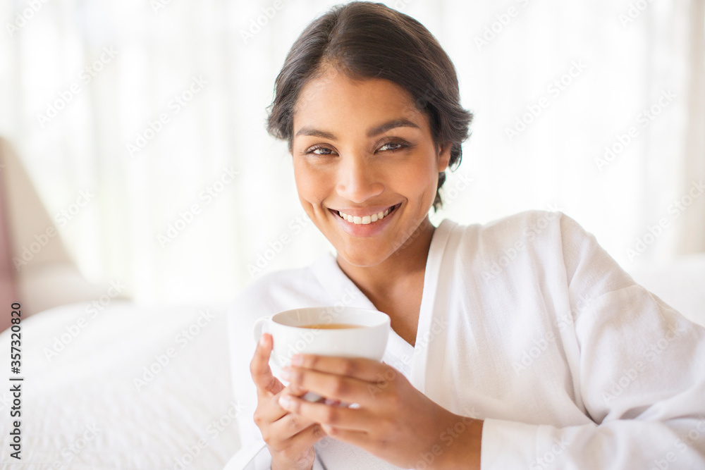 Portrait smiling woman in bathrobe drinking tea Portrait smiling woman in bathrobe drinking tea