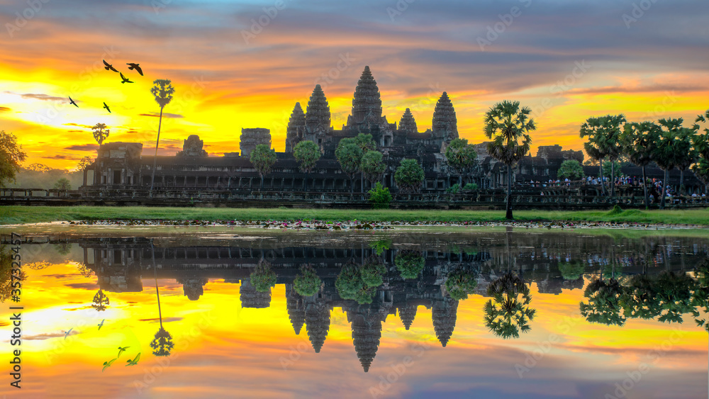 Sunrise view of popular tourist attraction ancient temple complex Angkor Wat with reflected in lake Siem Reap, Cambodia.