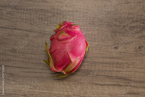 Dragon fruit on old wood background embed path