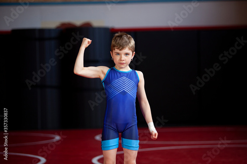 Young female wrestler in a blue singlet