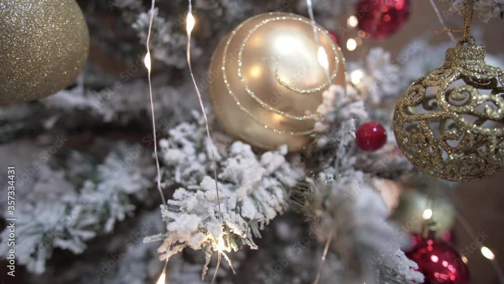 Detail shot of Christmas tree branches hung with ribbons and Christmas toys Detail shot of Christmas tree branches hung with ribbons and Christmas toys