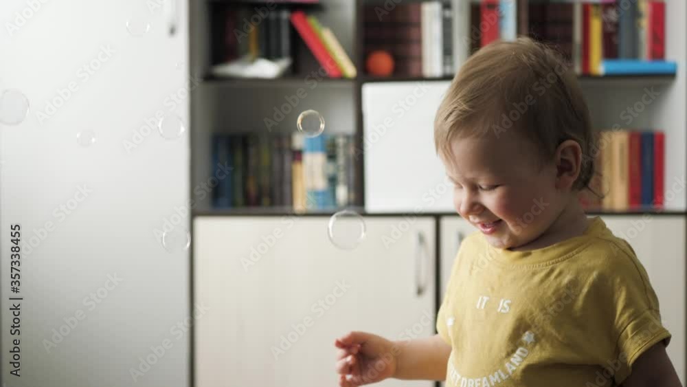 Baby rejoices in falling soap bubbles Baby rejoices in falling soap bubbles
