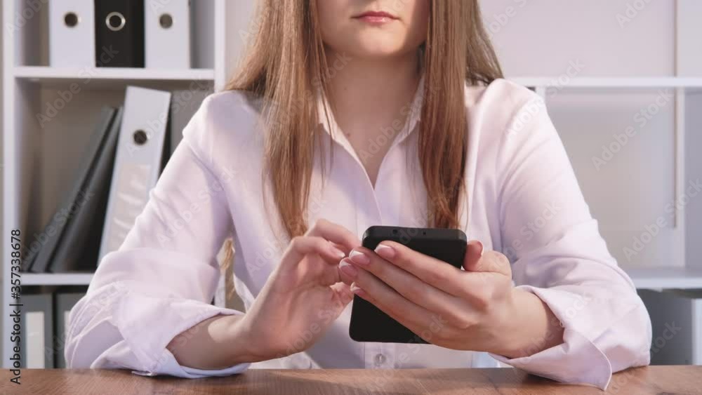 Business technology. Social media marketing. Woman using mobile app on smartphone at home office. Business technology. Social media marketing. Woman using mobile app on smartphone at home office.