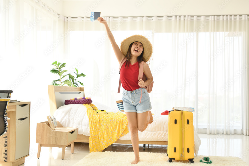 Happy Asian woman ready for travel with suitcase and passport.. Happy Asian woman ready for travel with suitcase and passport..