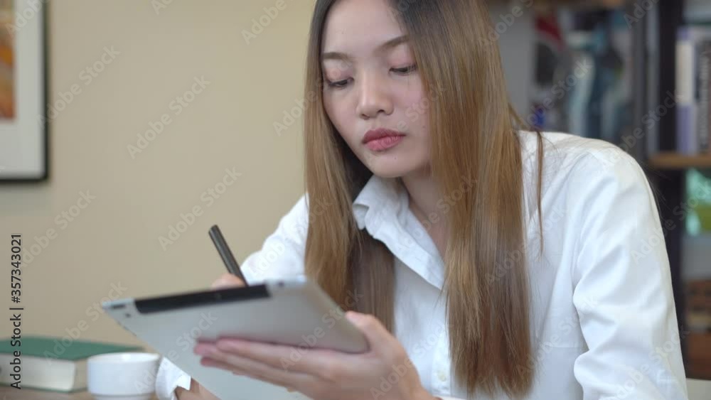 Young beautiful woman works for a computer from a home with a laptop on desk as a freelancer Young beautiful woman works for a computer from a home with a laptop on desk as a freelancer
