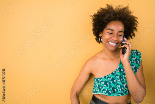 Young afro woman talking on the phone.