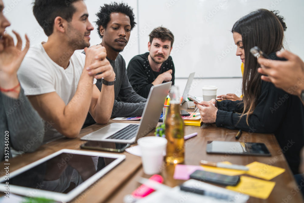 Multiethnic creative people having a brainstorming meeting. Multiethnic creative people having a brainstorming meeting.