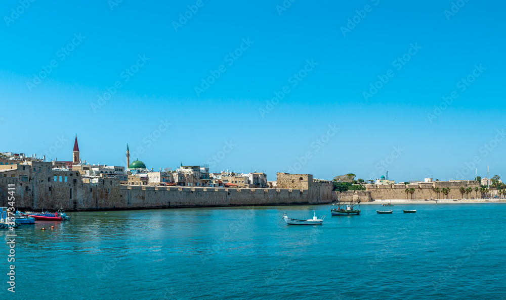 Port of Akko Acre with boats and mosque and the old city in the background, Israel.