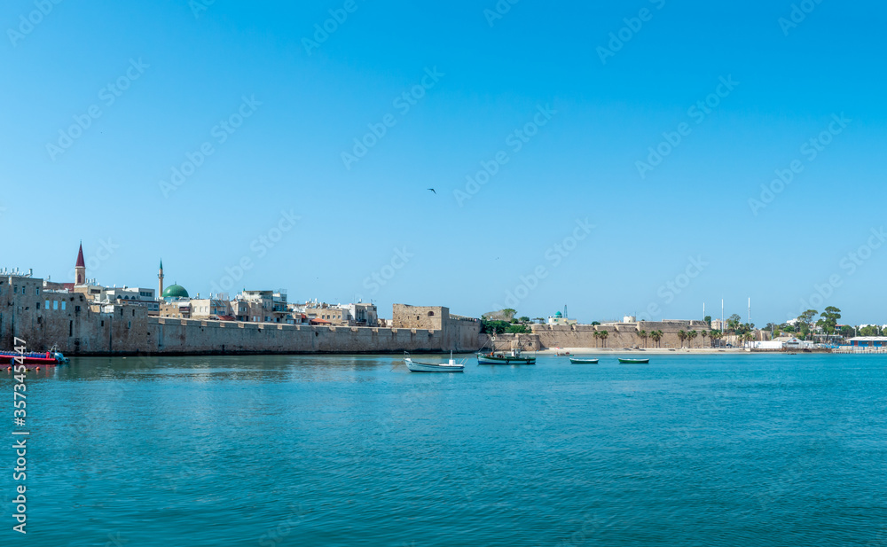 Port of Akko Acre with boats and mosque and the old city in the background, Israel.