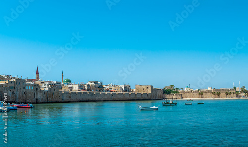 Port of Akko Acre with boats and mosque and the old city in the background  Israel.