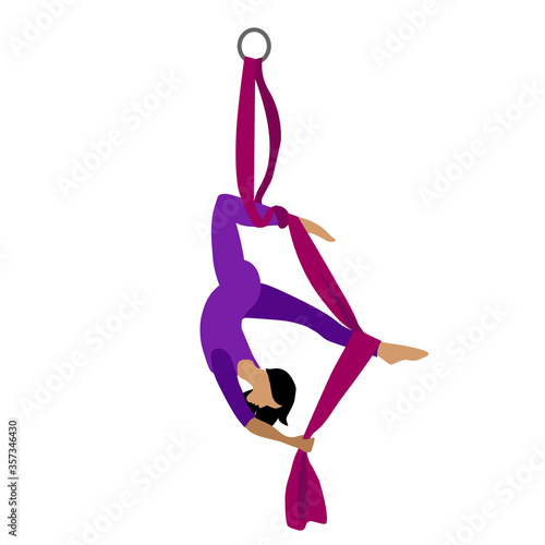 A young girl practices yoga with a ribbon or hammock. Aerial Yoga. Stretching exercises.