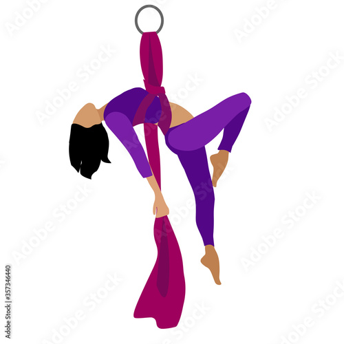 A young girl practices yoga with a ribbon or hammock. Aerial Yoga. Stretching exercises.