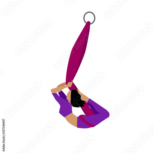 A young girl practices yoga with a ribbon or hammock. Aerial Yoga. Stretching exercises.