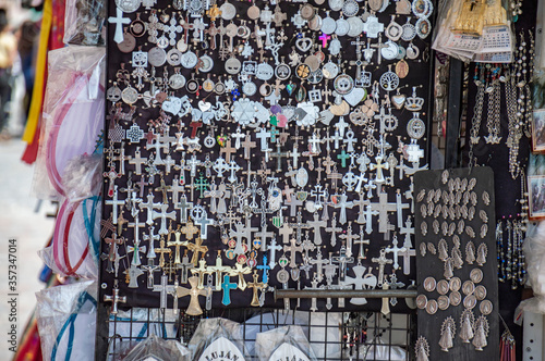 Obraz na płótnie Many crosses and medals of virgins at a street vendor stall in Lujan, Buenos Aires, Argentina w salonie
