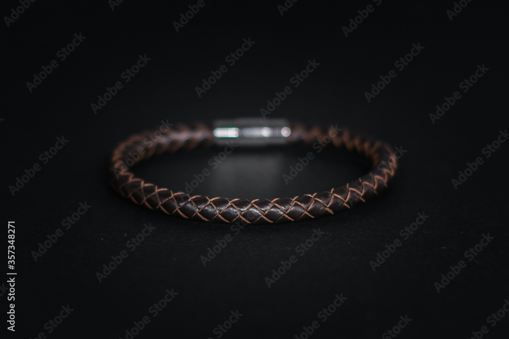 Men leather brown bracelet on black background Men leather brown bracelet on black background