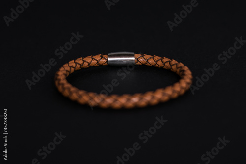 Canvas Print Men leather clear brown bracelet on black background
