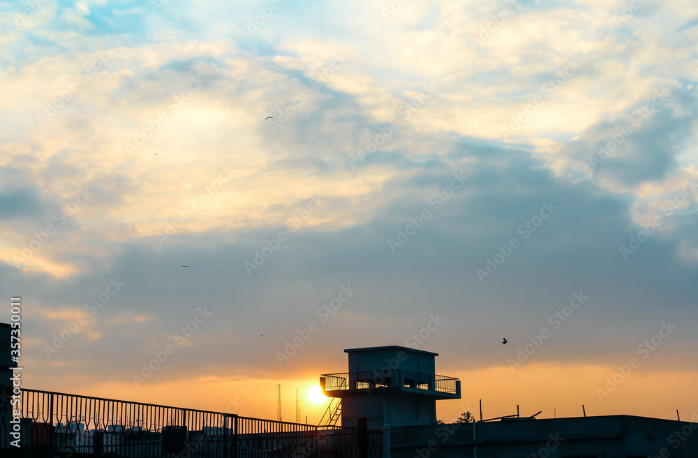 Beautifull sunset with some birds on roof top. Beautifull sunset with some birds on roof top.