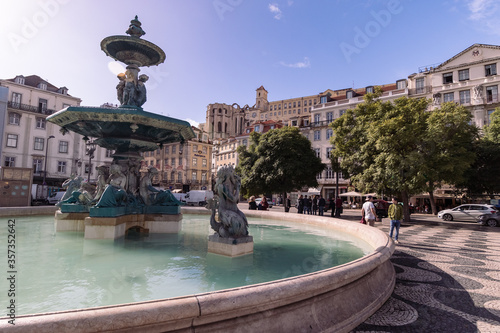 Lisbon / Portugal - 11 08 2018 - Fountain in Sunny Weather with Portugal Buildings and architecture on the background