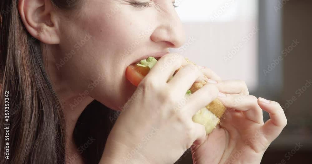 Hungry Woman Eating Burger Enjoying the Taste a Close up Shot on Red Camera
