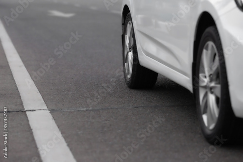 Close up of white car on the road © Keopaserth