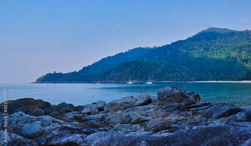 Beach landscape with huge boulders on a beach. Tioman Island, Malaysia. Beach landscape with huge boulders on a beach. Tioman Island, Malaysia.