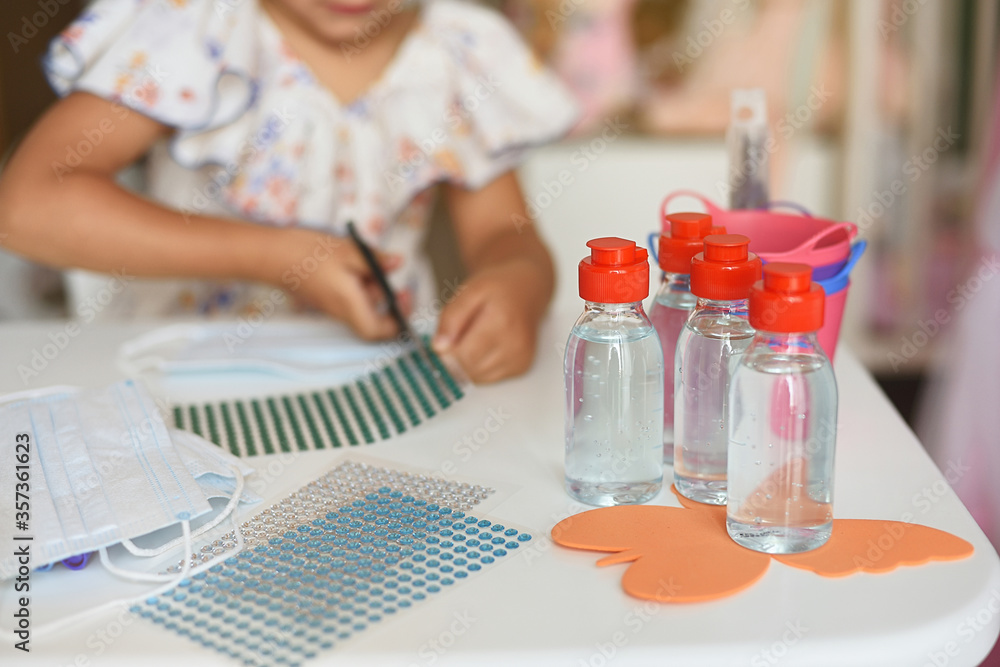 Plane detail of gel for children on the table of work and decoration of a girl. Selective focus Plane detail of gel for children on the table of work and decoration of a girl. Selective focus