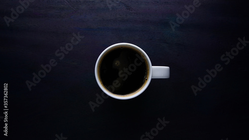 Coffee in white cup on black wooden table background, Black Coffee in white cup and on the gray wooden table, Top view