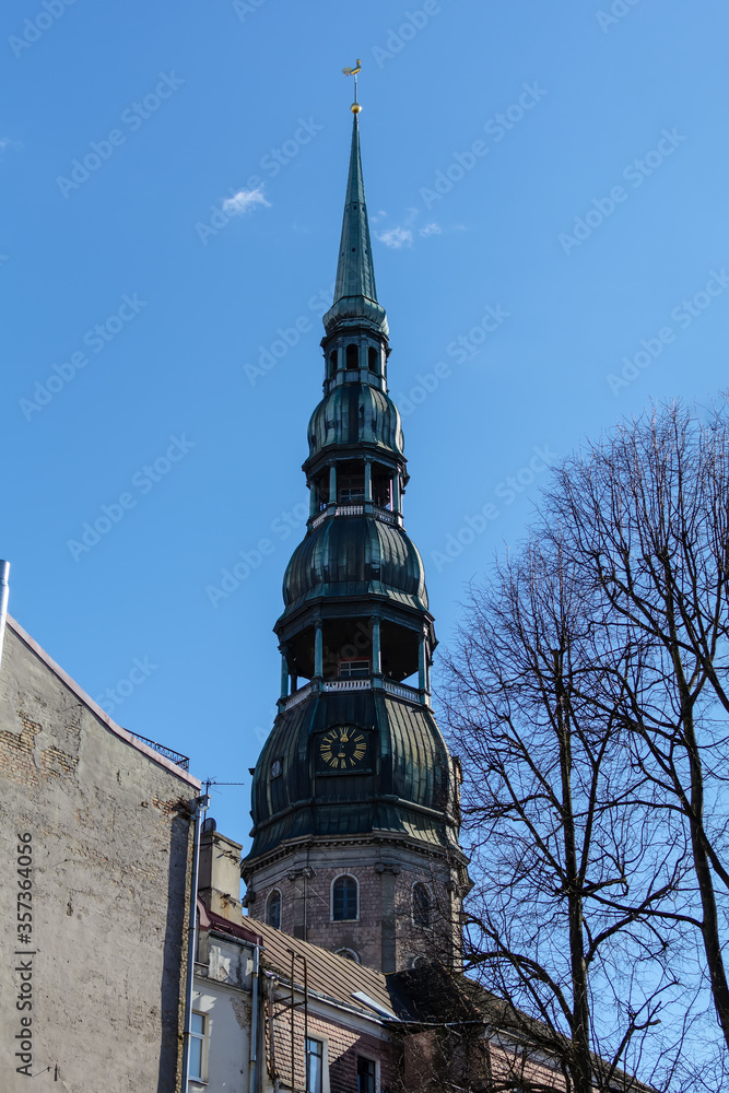 Obraz premium Tower of St. Peter’s Church with sphere and rooster atop the steeple. It is the tallest peak in Riga, and one of the oldest and most valuable monuments of medieval architecture in Baltic States.