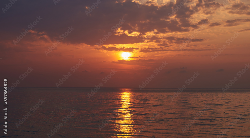 Landscape of paradise tropical island beach, sunrise shot. Beautiful sunrise over the tropical sea. Old fisherman boat at the distance.