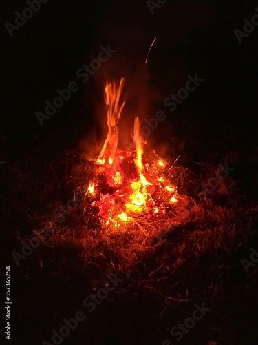bonfire in the grass at night. High quality photo © J_Koneva