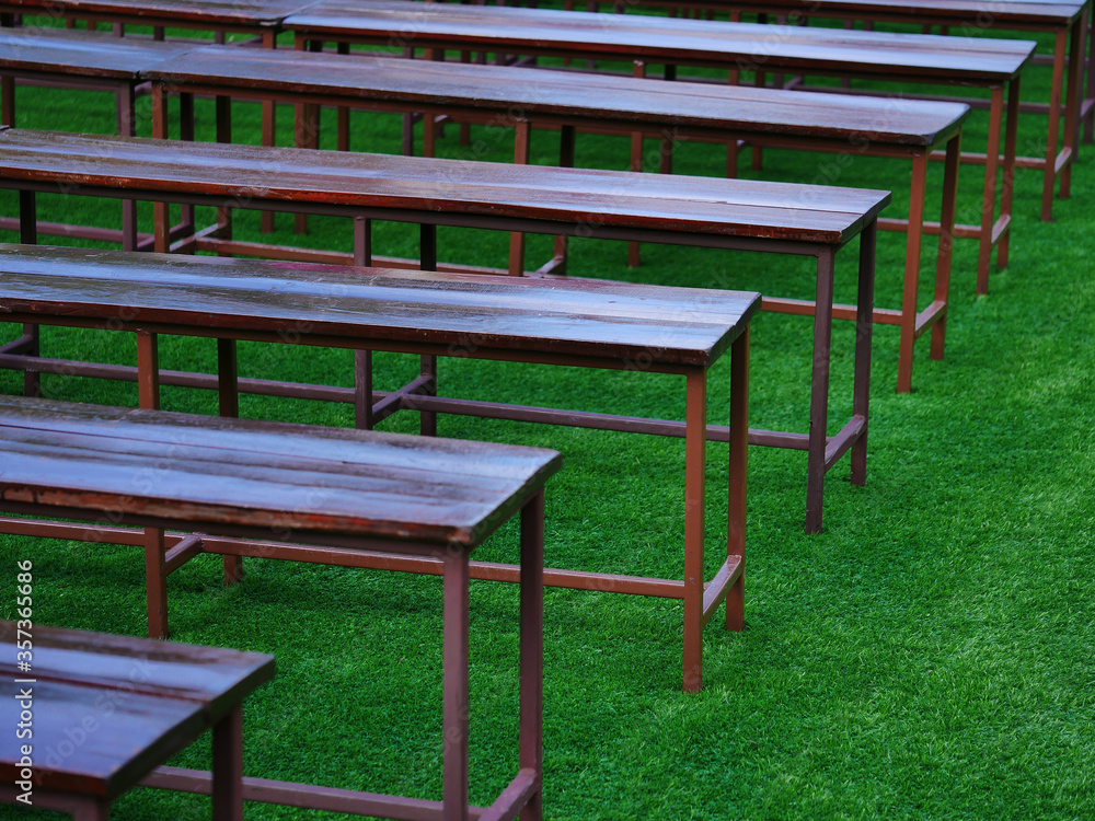 row of bench on green grass to take a seat for rest in garden or queue / design and background row of bench on green grass to take a seat for rest in garden or queue / design and background