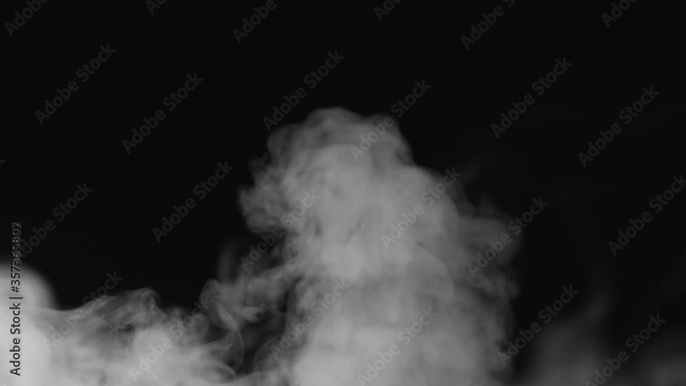 Slow motion water mist puff cloud over black background Slow motion water mist puff cloud over black background