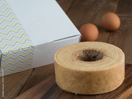 Baumkuchen, translated as tree cake, is a many-layered sponge cake baked on a rotating cylinder close-up on the table. horizontal  photo