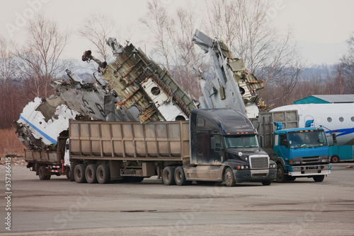 Parts of a disassembled jet loaded into a truck, aircraft scrap from a decommissioned aircraft.