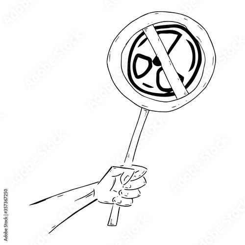 Hand holds a banner prohibiting nuclear weapons and nuclear testing. Sign prohibition of nuclear missiles and nuclear testing.