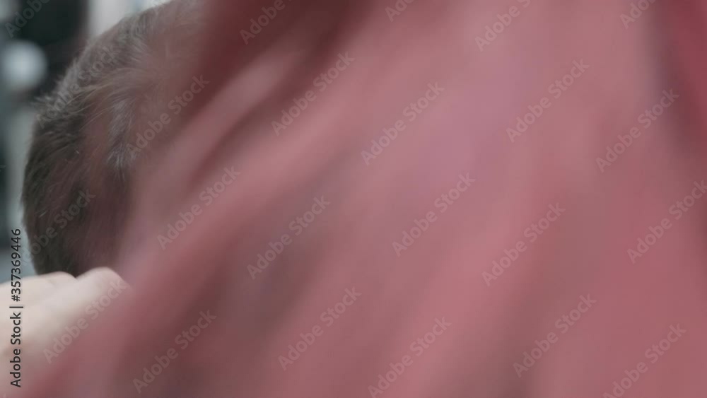 Cutting man hair with trimmer in salon. Close up head of guy with trendy haircut Cutting man hair with trimmer in salon. Close up head of guy with trendy haircut
