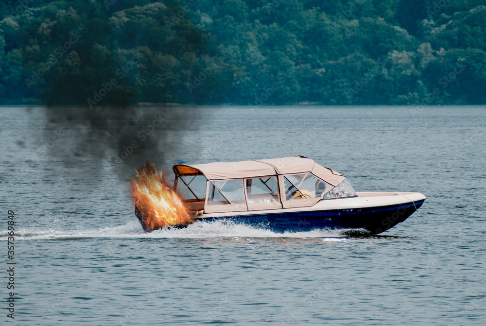 The boat is burning. The boat's engine caught fire. Motor boat used for ...