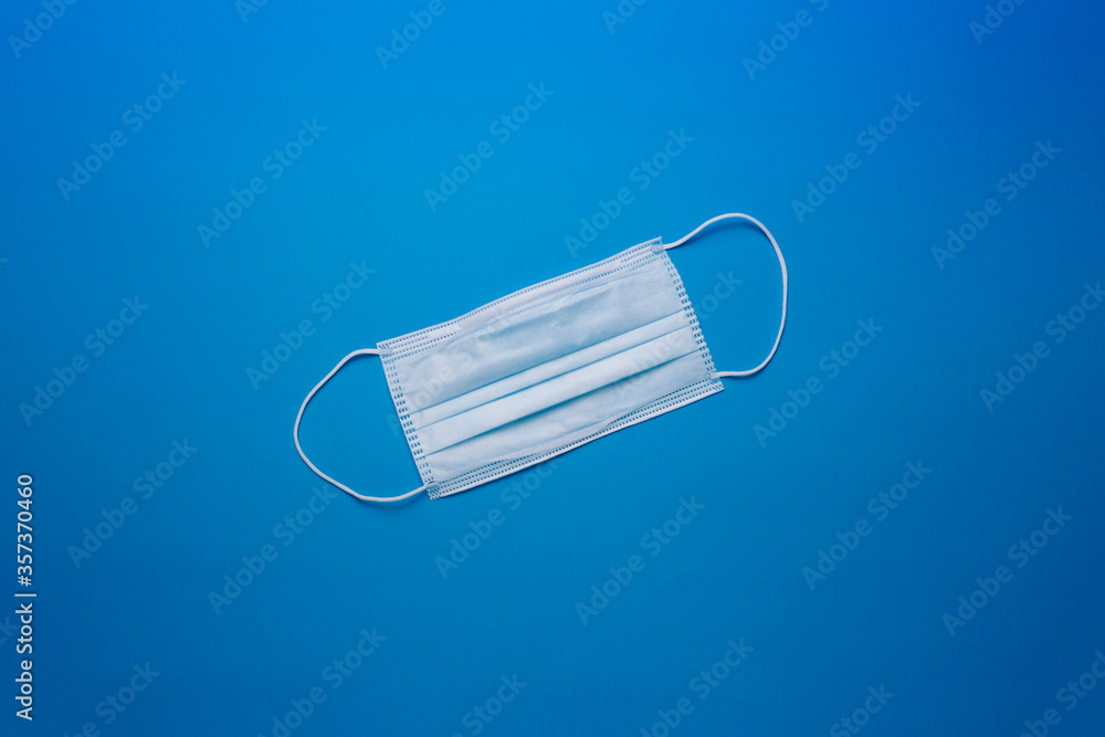 Medical mask on a blue backdrop background Medical mask on a blue backdrop background