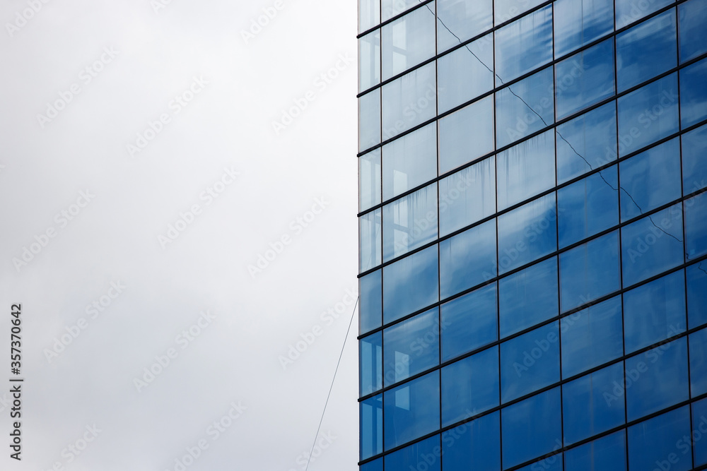 Blue windows of a modern glass skyscraper in the city. construction of business centers for offices in the central area of the city. Blue windows of a modern glass skyscraper in the city. construction of business centers for offices in the central area of the city.