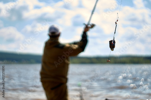 throwing a filled feeder . Closeup of feeder fishing © Степан Хаджи